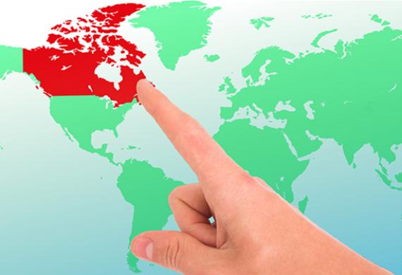 Imagem contém um dedo indicando o mapa do Canadá